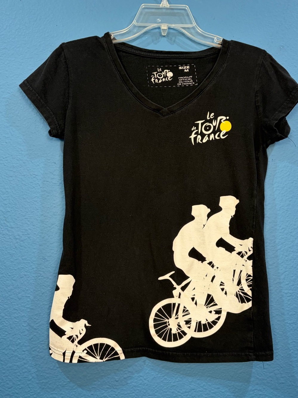 This is I believe an official Tour De France fitted v neck shirt. It has cyclist